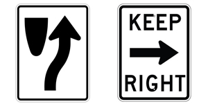 该路牌标记了一个交通安全岛或一个高速公路分隔线，或注明“KEEP RIGHT”，提醒驾驶员靠右边行驶。